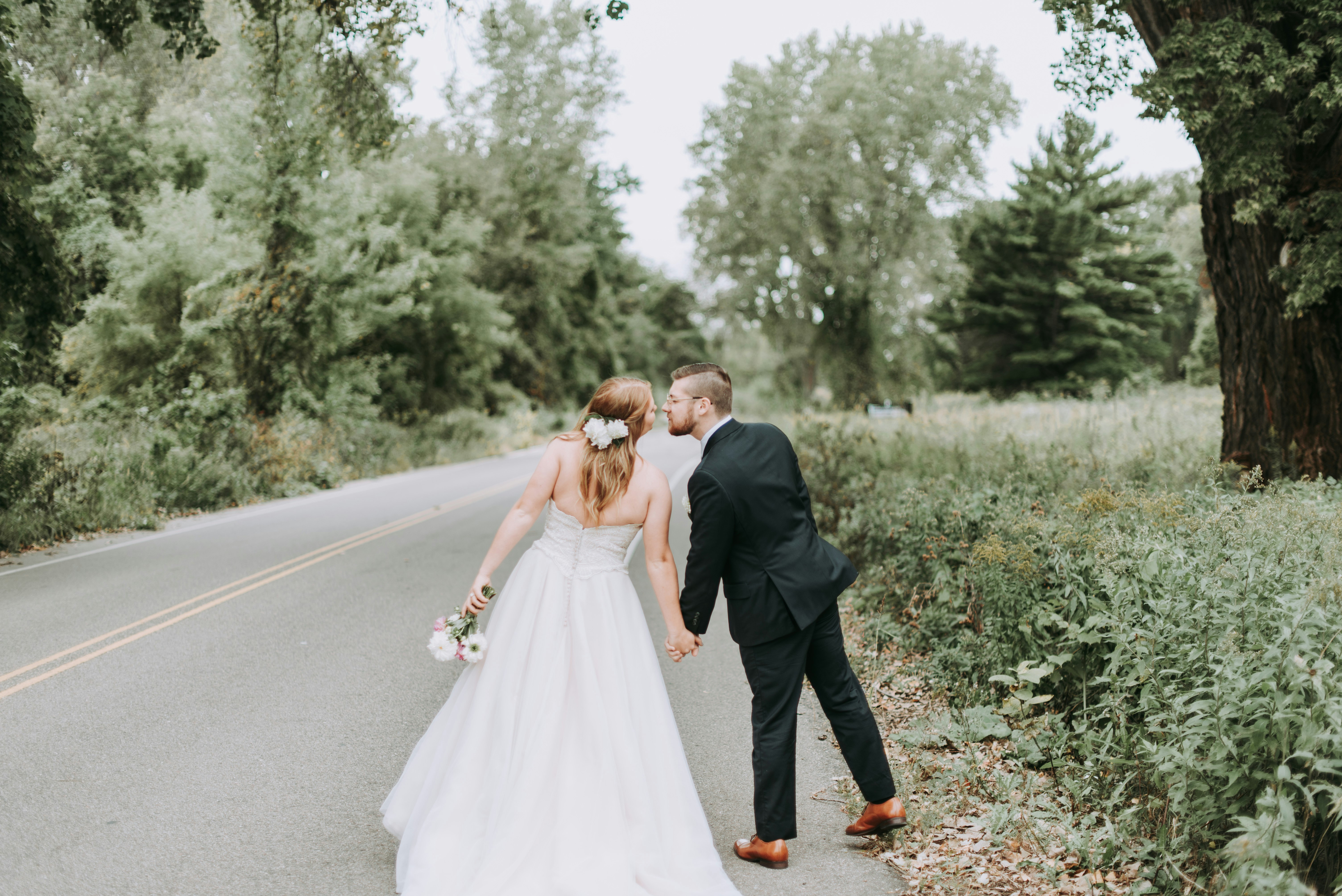 man and woman standing near tree